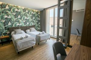 Posteľ alebo postele v izbe v ubytovaní Málaga Premium Hotel