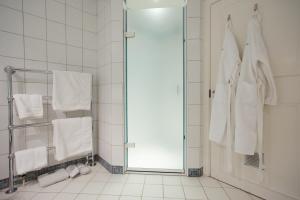 a bathroom with a shower and white towels at Goldstone Hall Hotel in Market Drayton