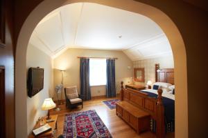 a bedroom with a bed and a tv in a room at Goldstone Hall Hotel in Market Drayton