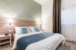 Ένα ή περισσότερα κρεβάτια σε δωμάτιο στο Hotel Mondo