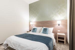 Ένα ή περισσότερα κρεβάτια σε δωμάτιο στο Hotel Mondo