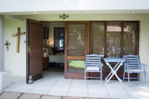a porch with a table and two chairs on it at De Zoete Rust Guesthouse in Centurion