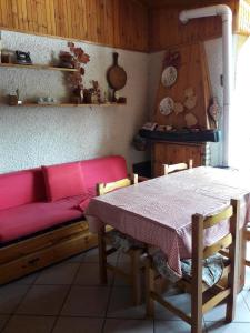 a living room with a red couch and a table at Condominio La Betulla in Campo di Giove