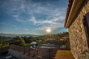 a view from a house with the sun in the sky at ROGGAKI Ionian Villas in Peratiá