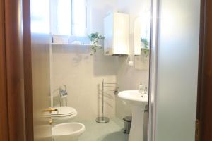 a white bathroom with a toilet and a sink at La Palombara in Ponzano Romano +32 photos