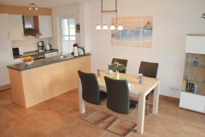 a kitchen and dining room with a table and chairs at 5*Ferienwohnung Seeblick 2 in Wendisch Rietz