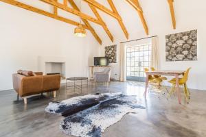a living room with a couch and a table at Druk My Niet Wine Estate in Paarl
