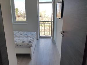 a hallway with a door and a bench and a window at Lakefive Apartments Balatonfüred in Balatonfüred