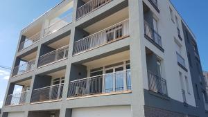 an apartment building with balconies on the side of it at Lakefive Apartments Balatonfüred in Balatonfüred