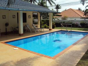 a large blue swimming pool next to a house at Mountain View Villa in Sam Roi Yot