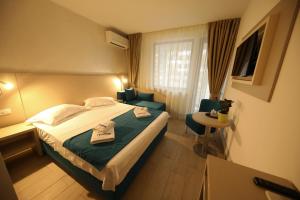 Postel nebo postele na pokoji v ubytování Hotel Delfin
