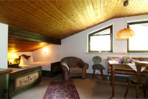 a living room with a bed and a table and chairs at Ferienwohnungen Oberau in Berchtesgaden
