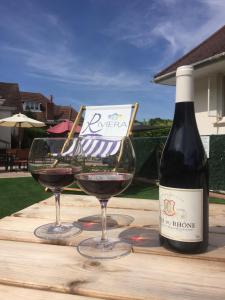 a bottle of wine and two glasses on a table at The Riviera Hotel & Apartments - Alum Chine in Bournemouth