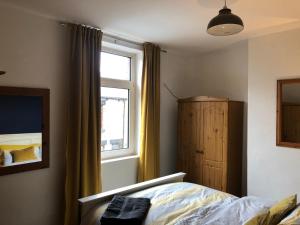 a bedroom with a bed and a window at Hilton House in Barnsley