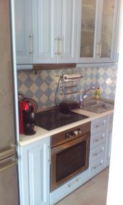 a kitchen with a sink and a stove top oven at Glyfada Corfu Apartment in Glyfada