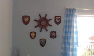 a wall with a clock andaques on a wall at Glyfada Corfu Apartment in Glyfada