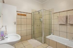 a bathroom with a shower and a tub and a sink at La La DaThel Guesthouse in Colesberg +29 photos