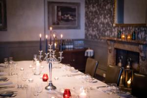 a table with candles on it in a restaurant at Hotel Du Vin, St Andrews in St. Andrews