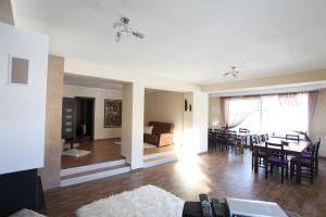 a living room and dining room with a table and chairs at Ashkova House in Govedartsi