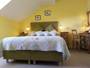 a bedroom with a bed and a table and chairs at Drumcreehy Country House B&B in Ballyvaughan
