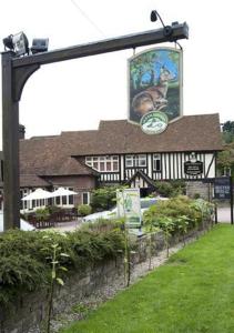 a building with a sign in front of it at Roebuck by Greene King Inns in Forest Row