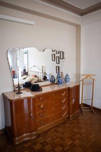 a room with a dresser with a large mirror at Casa Carlotta in Mestre