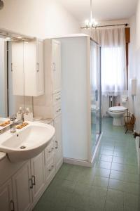 a bathroom with a sink and a shower and a toilet at Casa Carlotta in Mestre