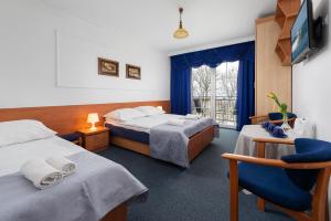 a hotel room with two beds and a window at Willa Dalia in Władysławowo
