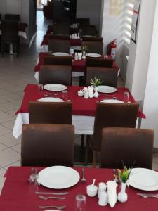 a row of tables with red and white plates on them at Oreko Express in Afyon