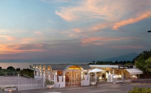 a building with a sunset in the background at Hotel Rivage in Sorrento