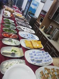 a long line of plates of food on a table at Oreko Express in Afyon