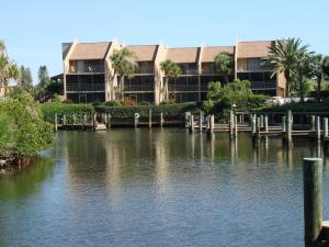 a building with a marina next to a body of water at Midnight Cove #532, Bayside in Siesta Key, FL in Siesta Key