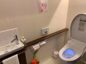 a bathroom with a white toilet and a sink at Ocean Resort House 205 in Onna +17 photos