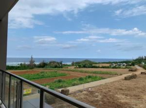 a balcony of a house with a view of the ocean at Ocean Resort House 205 in Onna