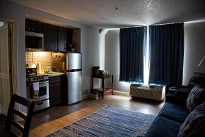 a living room with a couch and a kitchen at McCoy's Inn in Ripley