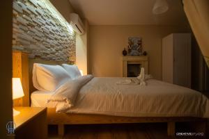 En eller flere senge i et værelse på Dolce Casa Boutique Hotel