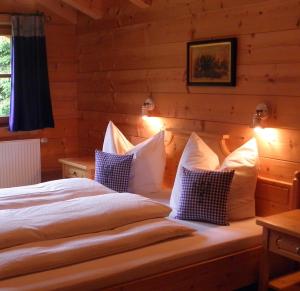 a bedroom with a bed in a log cabin at Family Lodge Maximilian in Tux