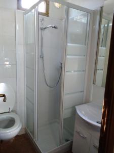 a bathroom with a shower with a toilet and a sink at Camping Pineta in Calambrone