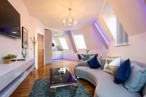 a living room with a couch and a table at Leeds Super Luxurious Apartments in Leeds