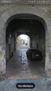een auto geparkeerd onder een boog in een stenen tunnel bij Casa Castellano in Nola