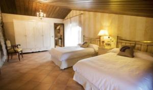 a hotel room with two beds in a room at Casa rural l`Avellana in Pinell de Solsones +30 photos