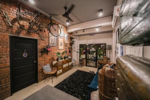 a room with a bike hanging on a brick wall at The Best Hotel in Bayan Lepas - THE LOV PENANG in Bayan Lepas