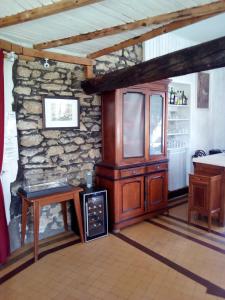 a room with a stone wall with a table and a cabinet at Les 4 Montagnes in Villard-de-Lans +25 photos