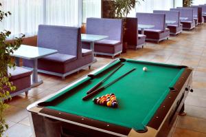 a pool table with cue balls on top of it at KAKTUS Hotel Kaktus Albir in Albir