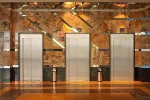 a row of three elevators in a building at KAKTUS Hotel Kaktus Albir in Albir