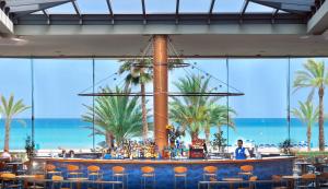 a bar at the beach with a view of the ocean at KAKTUS Hotel Kaktus Albir in Albir