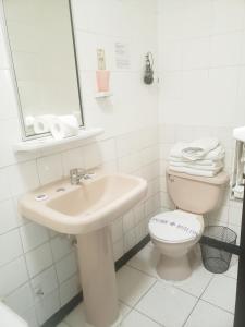 a white bathroom with a sink and a toilet at Hotel Concorde in Arica +21 photos
