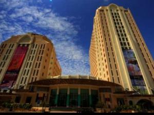 two tall white buildings with a blue sky in the background at AlRayani Guest Room, Homestay Kota bharu in Kota Bharu