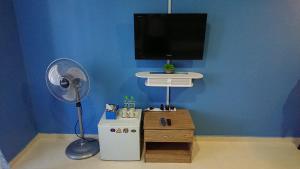 a room with a fan and a blue wall at AlRayani Guest Room, Homestay Kota bharu in Kota Bharu
