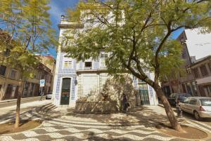 a building with a fountain in the middle of a street at Rose Green Loft in Porto